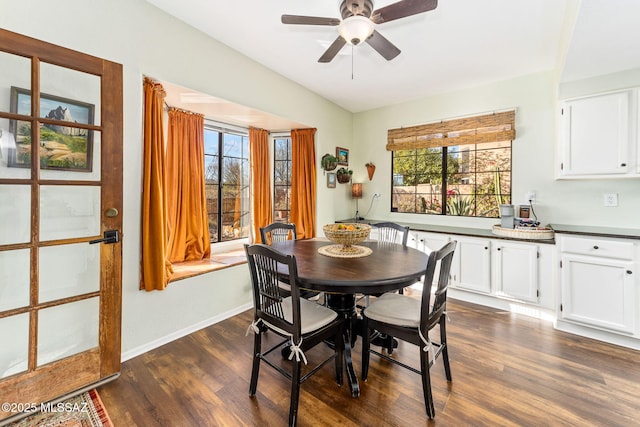 dining area featuring dark wood-type flooring and ceiling fan