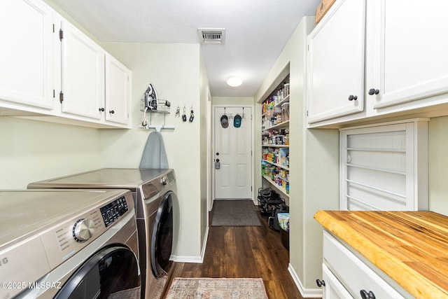 washroom featuring cabinets, dark hardwood / wood-style floors, and separate washer and dryer