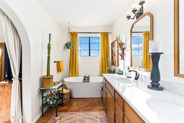 bathroom with vanity, a bath, and tile patterned flooring