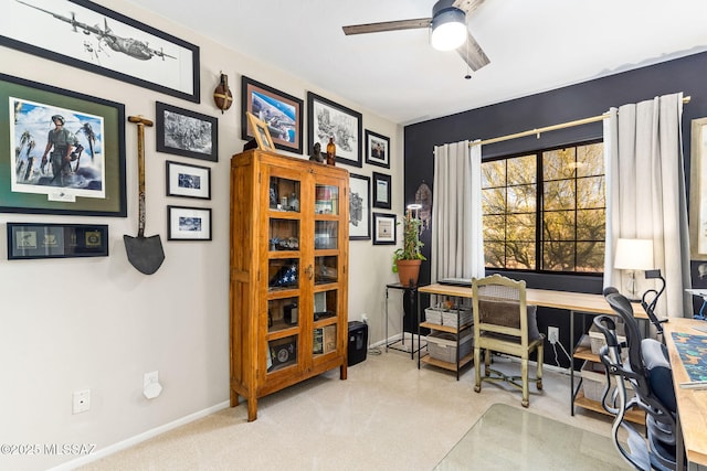 carpeted office space featuring ceiling fan