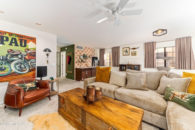 living room with light colored carpet and ceiling fan