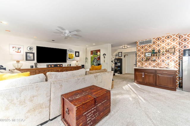 carpeted living room featuring ceiling fan