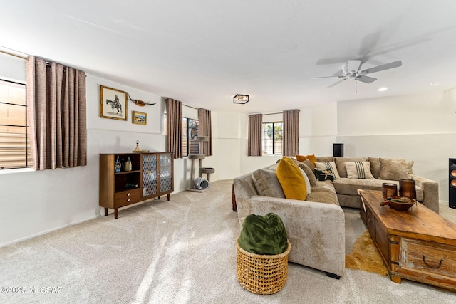 carpeted living room featuring ceiling fan