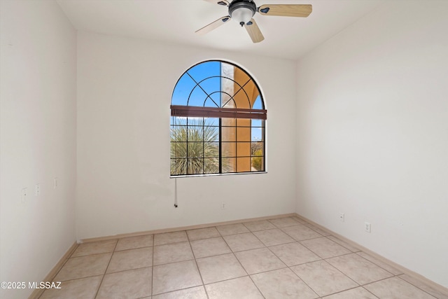 tiled empty room featuring ceiling fan