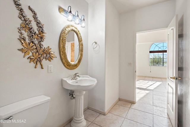 bathroom with tile patterned flooring and toilet