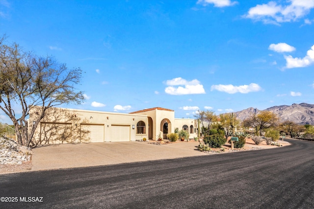 view of front of home featuring a garage and a mountain view