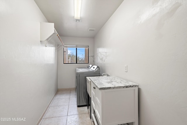 washroom with light tile patterned flooring and washer and clothes dryer