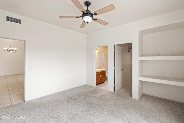 unfurnished bedroom with light colored carpet, ensuite bathroom, and ceiling fan with notable chandelier