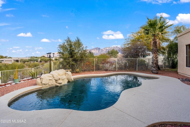 view of pool with a mountain view and a patio area