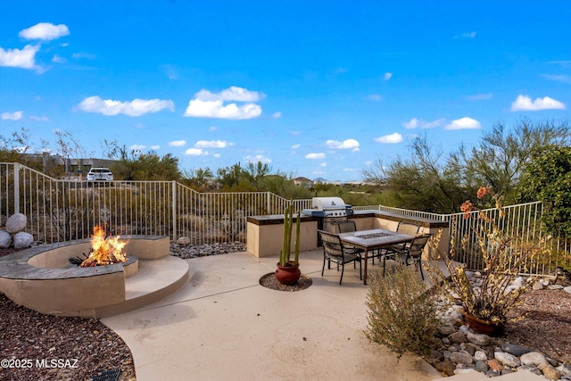 view of patio / terrace with an outdoor fire pit