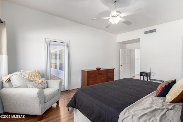 bedroom with wood finished floors, visible vents, and a ceiling fan