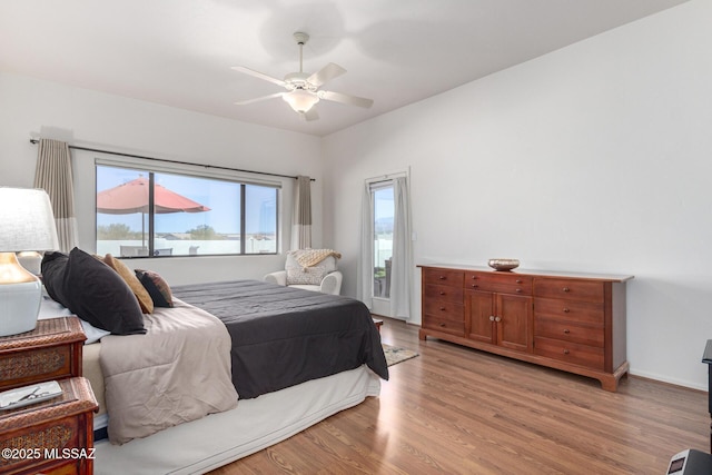 bedroom featuring light wood-style floors, ceiling fan, and baseboards