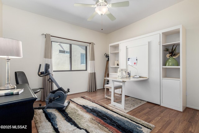 home office with ceiling fan and dark wood-type flooring