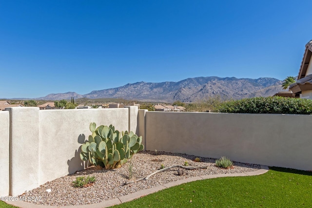 view of yard featuring a fenced backyard and a mountain view