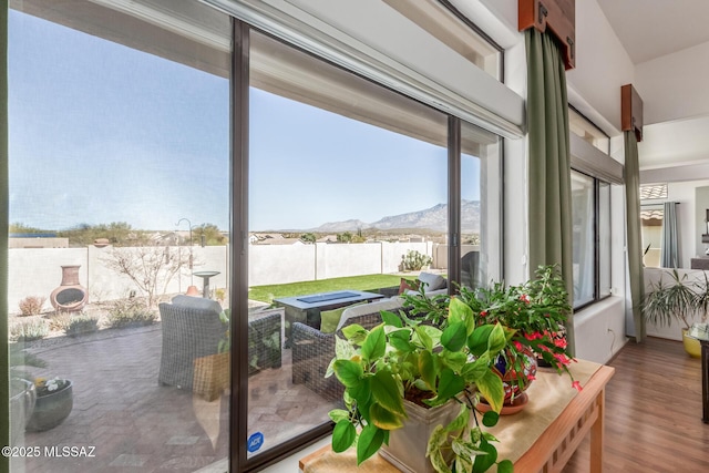 sunroom / solarium featuring a mountain view