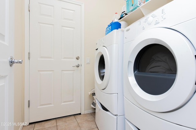 laundry area with separate washer and dryer and light tile patterned floors