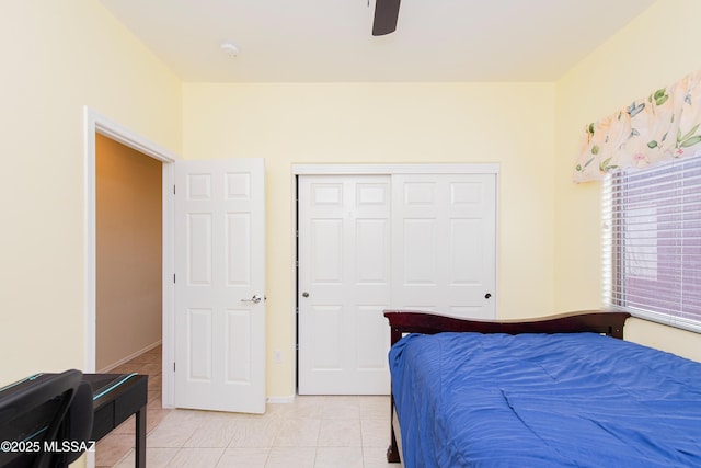 tiled bedroom with a closet and ceiling fan