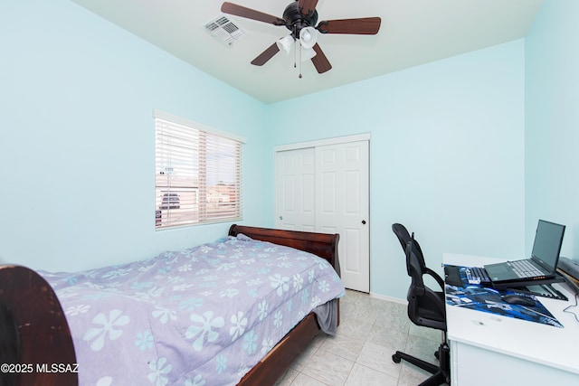 bedroom with light tile patterned flooring, ceiling fan, and a closet