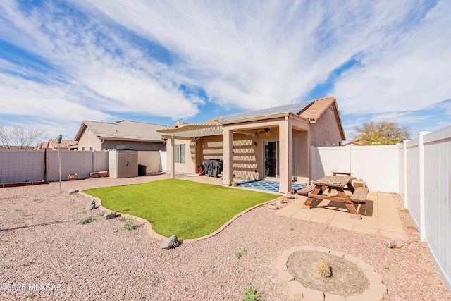 back of house with a yard and a patio area