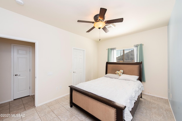 tiled bedroom featuring ceiling fan