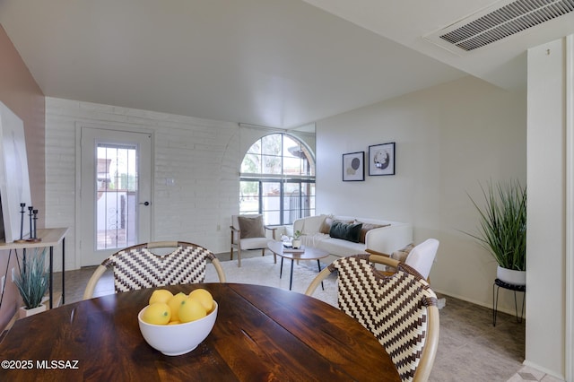 328 S Paseo Pena Unit C, Green Valley, AZ 85614 - dining room with visible vents, light tile patterned floors, and brick wall