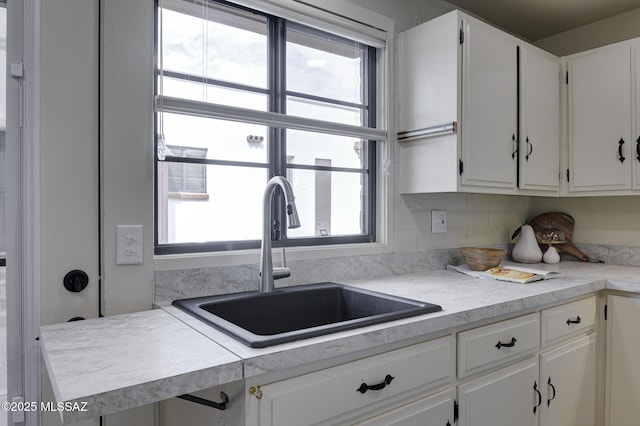 328 S Paseo Pena Unit C, Green Valley, AZ 85614 - kitchen with white cabinetry, light countertops, and a sink