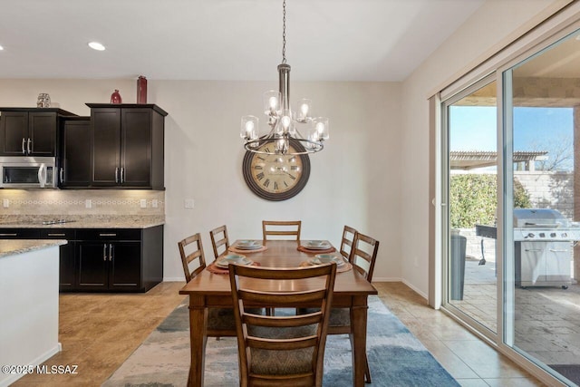 dining space with light tile patterned flooring, baseboards, a notable chandelier, and recessed lighting