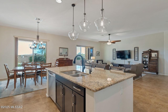 kitchen featuring a sink, visible vents, ceiling fan with notable chandelier, light stone counters, and dishwasher