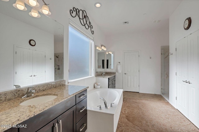 bathroom with vanity, plus walk in shower, and plenty of natural light