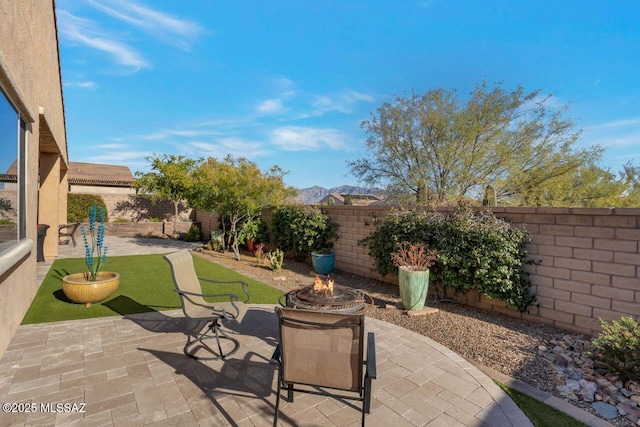 view of patio / terrace with a fenced backyard and a fire pit