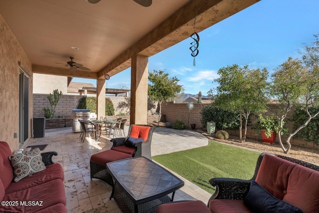 view of patio featuring ceiling fan, a fenced backyard, outdoor lounge area, and outdoor dining area