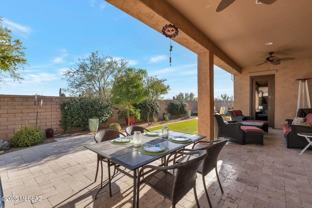 view of patio featuring an outdoor hangout area, a ceiling fan, outdoor dining space, and a fenced backyard