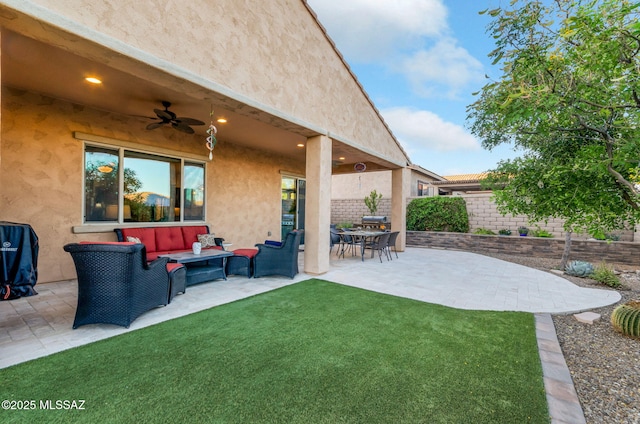 view of yard featuring a ceiling fan, a patio area, a fenced backyard, and an outdoor living space