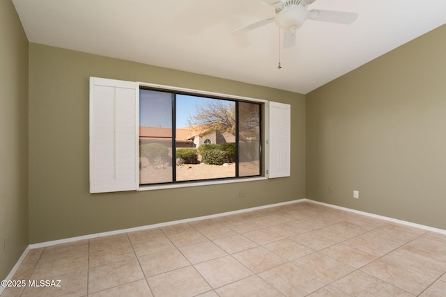 unfurnished room featuring light tile patterned flooring, ceiling fan, and baseboards