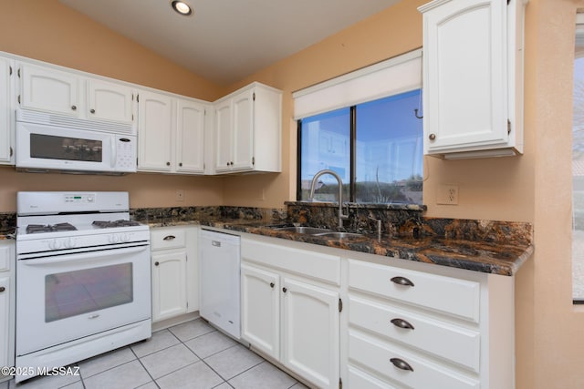 kitchen featuring lofted ceiling, white appliances, and white cabinets