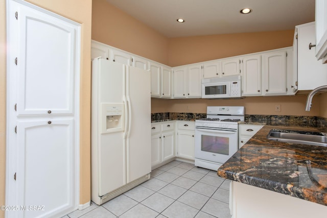 kitchen featuring light tile patterned floors, recessed lighting, white cabinets, a sink, and white appliances