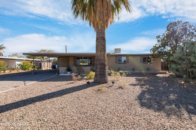 view of front of property featuring a carport