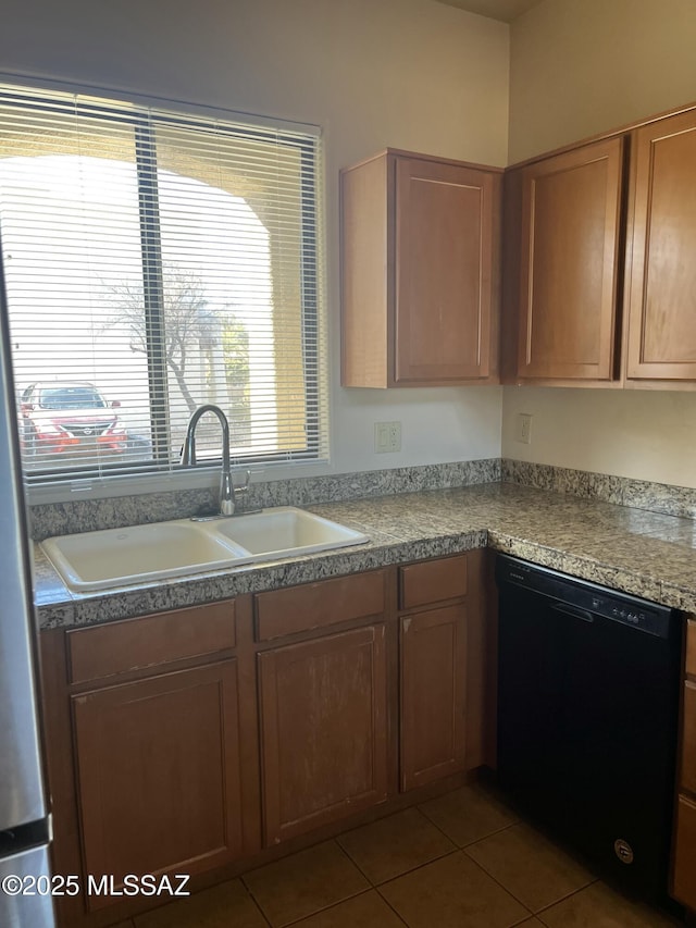 kitchen featuring tile patterned flooring, dishwasher, and sink