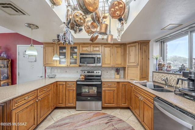 3910 S Via Del Ruisenor, Green Valley, AZ 85622 - kitchen with sink, light tile patterned floors, appliances with stainless steel finishes, tasteful backsplash, and kitchen peninsula