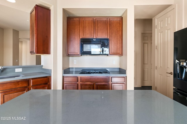 kitchen with sink and black appliances