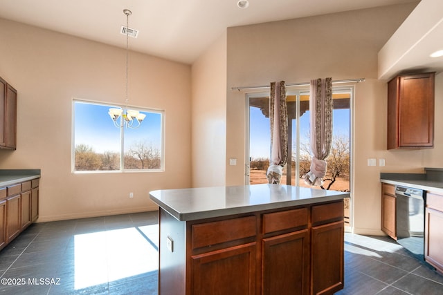 kitchen with stainless steel dishwasher, plenty of natural light, a kitchen island, and hanging light fixtures