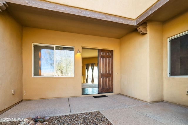 entrance to property with a patio