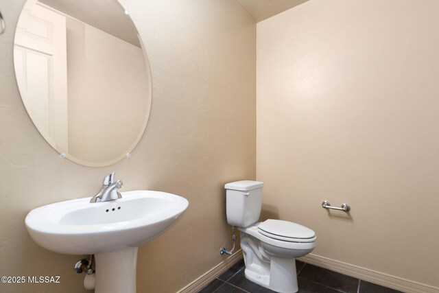 bathroom with toilet and tile patterned flooring