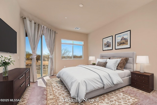 carpeted bedroom featuring access to exterior