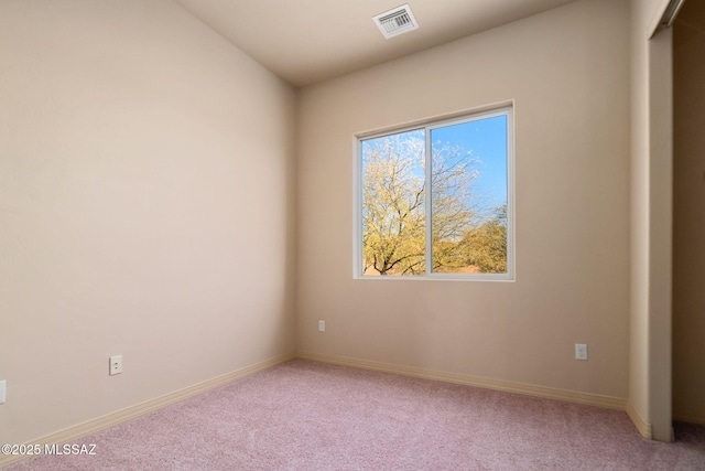 unfurnished room featuring light carpet