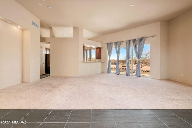 unfurnished living room with dark colored carpet