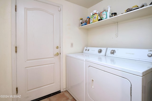 laundry area with light tile patterned flooring and washer and dryer