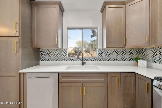 kitchen featuring stainless steel gas stove, sink, backsplash, and dishwasher