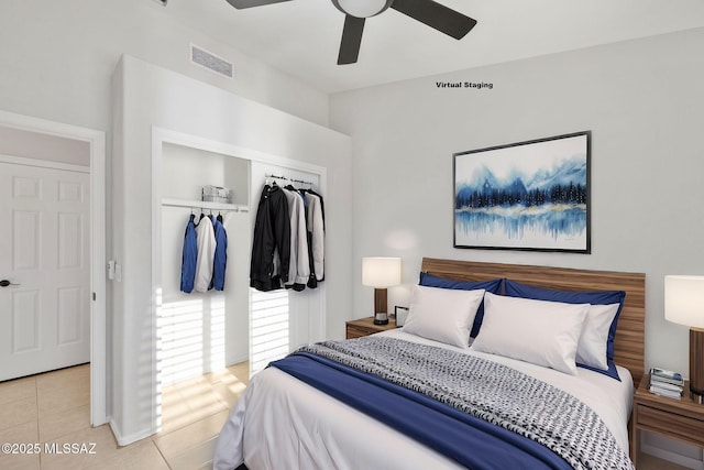 tiled bedroom featuring ceiling fan and a closet