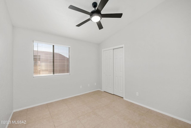 unfurnished bedroom with lofted ceiling, a closet, and ceiling fan